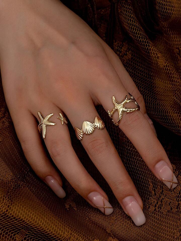 Juego de anillos de ensueño con estrellas de mar y conchas